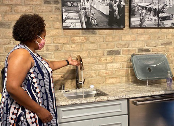 Woman shopping for kitchen and bathroom touchless faucets in our Eatontown Store